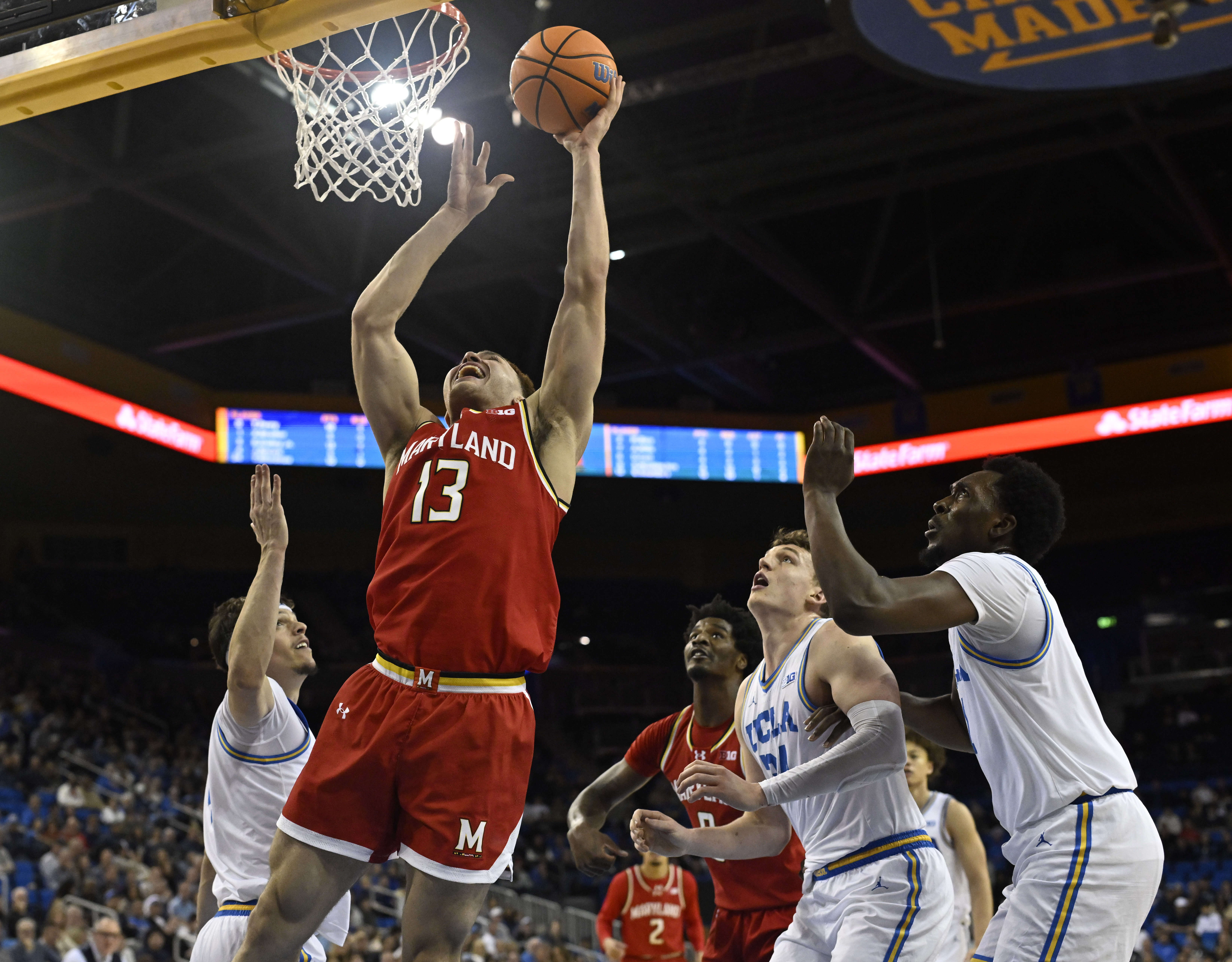 Forward Elijah Saunders #13 of the Maryland Terrapins drives to...