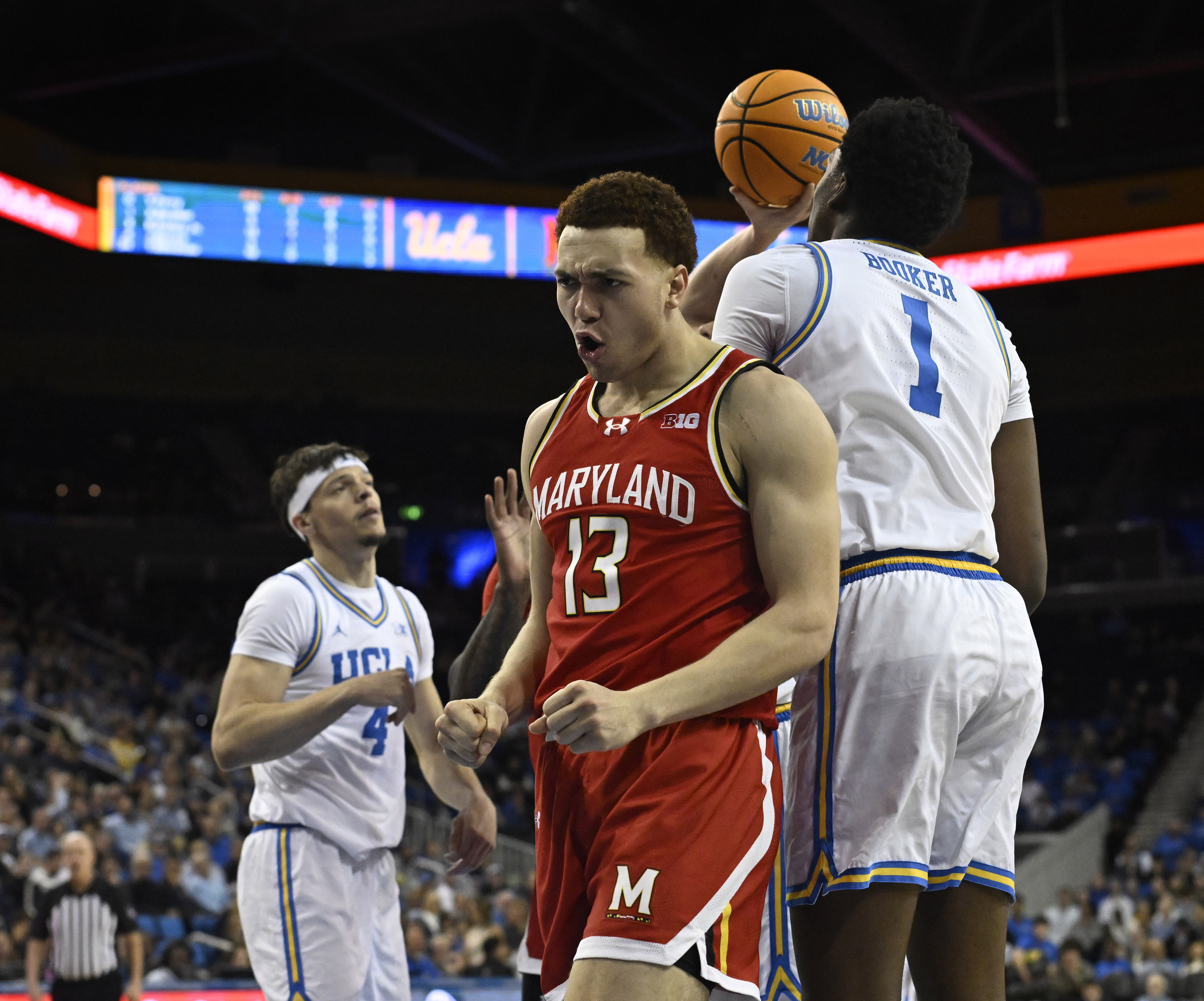 Forward Elijah Saunders #13 of the Maryland Terrapins reacts after...