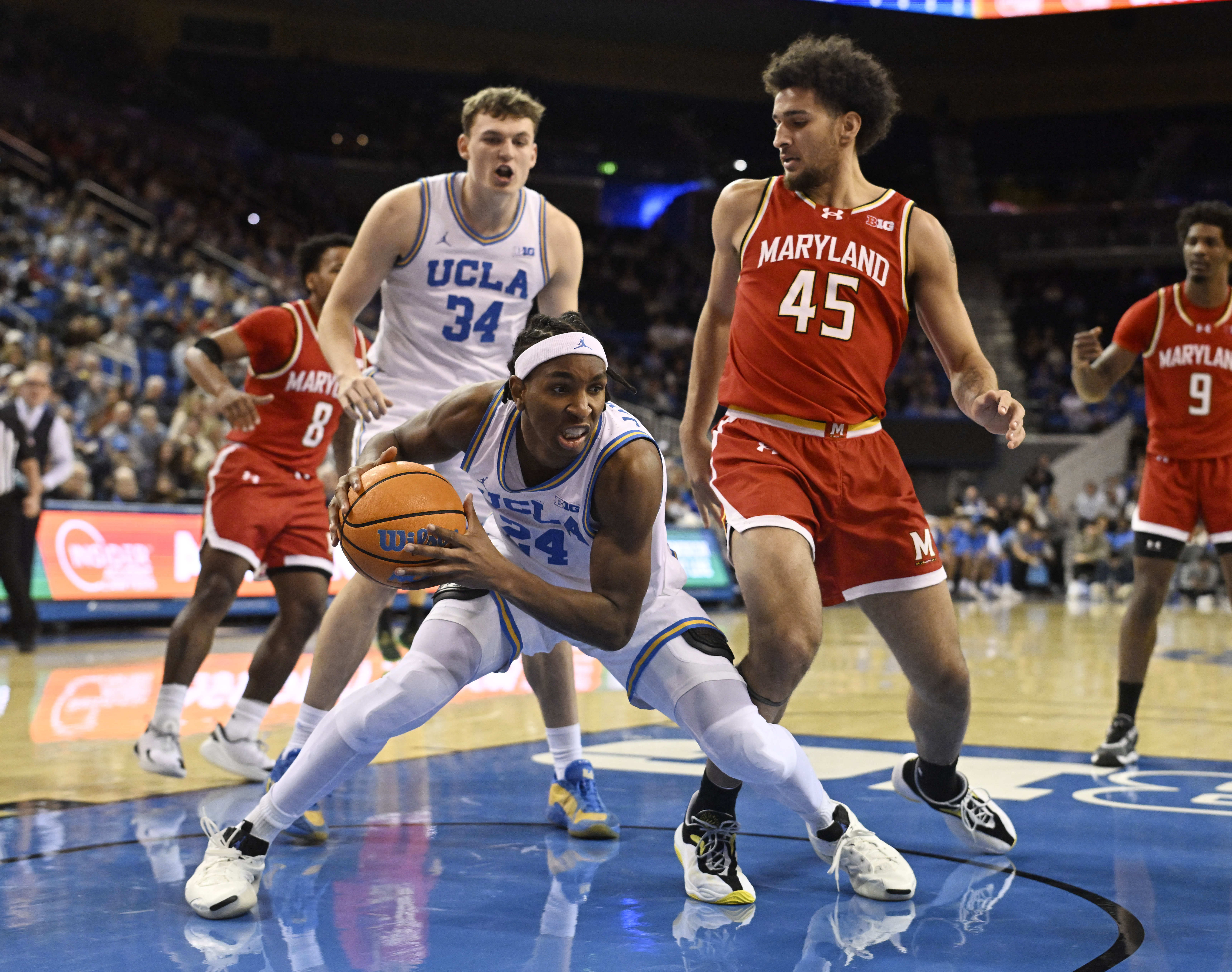 Center Steven Jamerson II #24 of the UCLA Bruins rebounds...