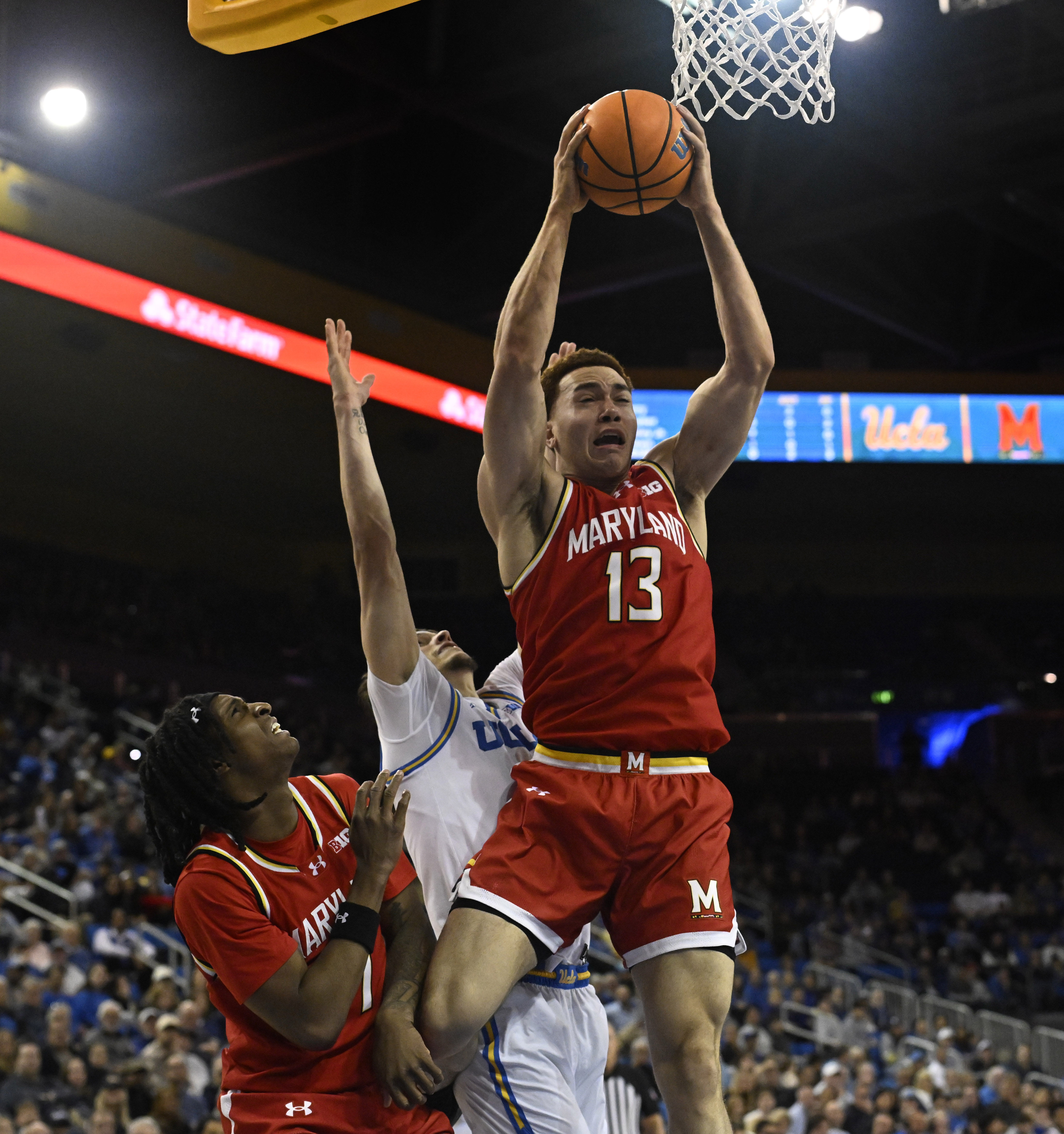 Forward Elijah Saunders #13 of the Maryland Terrapins rebounds against...