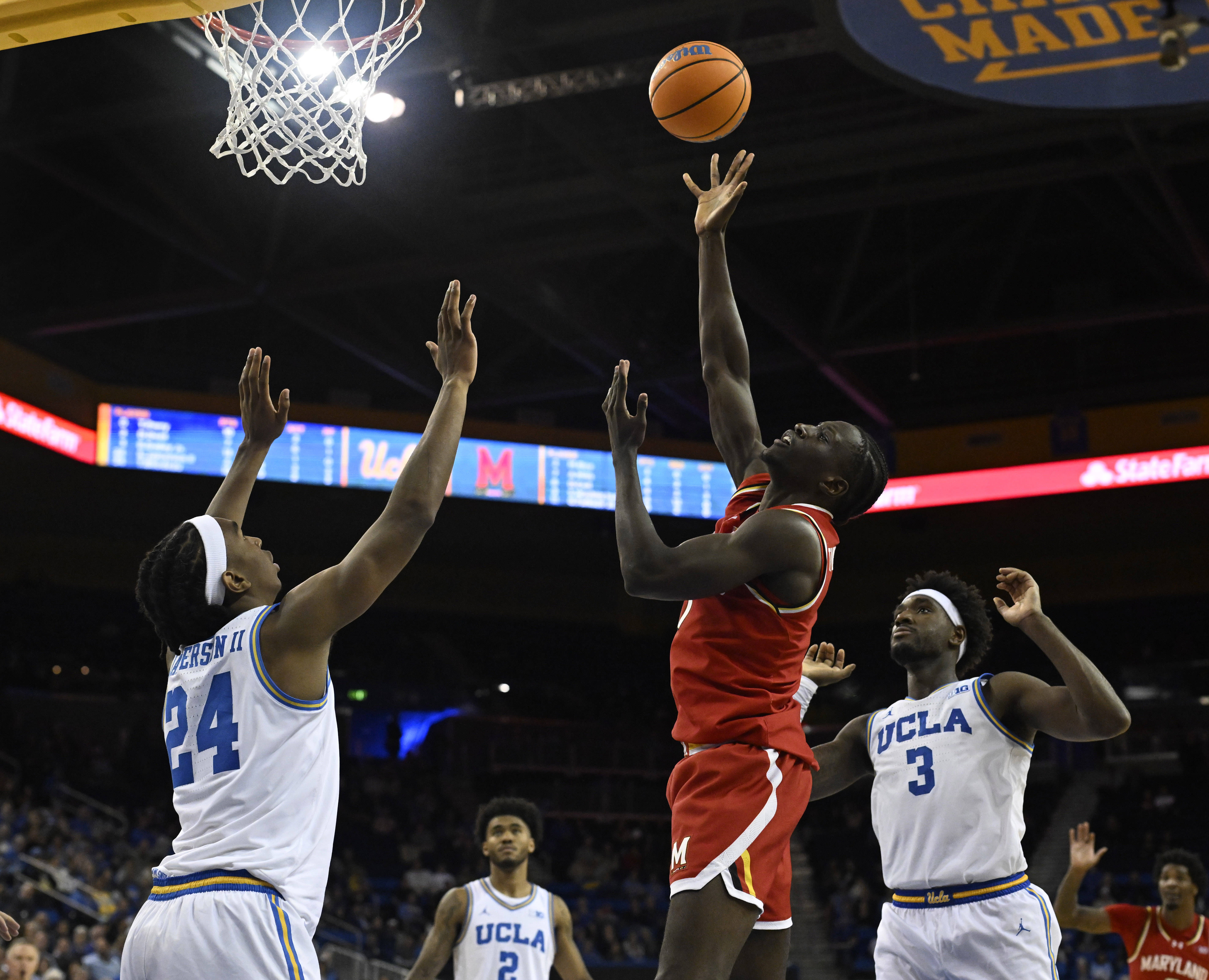 Guard George Turkson Jr. #11 of the Maryland Terrapins shoots...