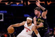 Detroit Pistons guard Cade Cunningham (2) looks to pass the ball while being guarded by Los...