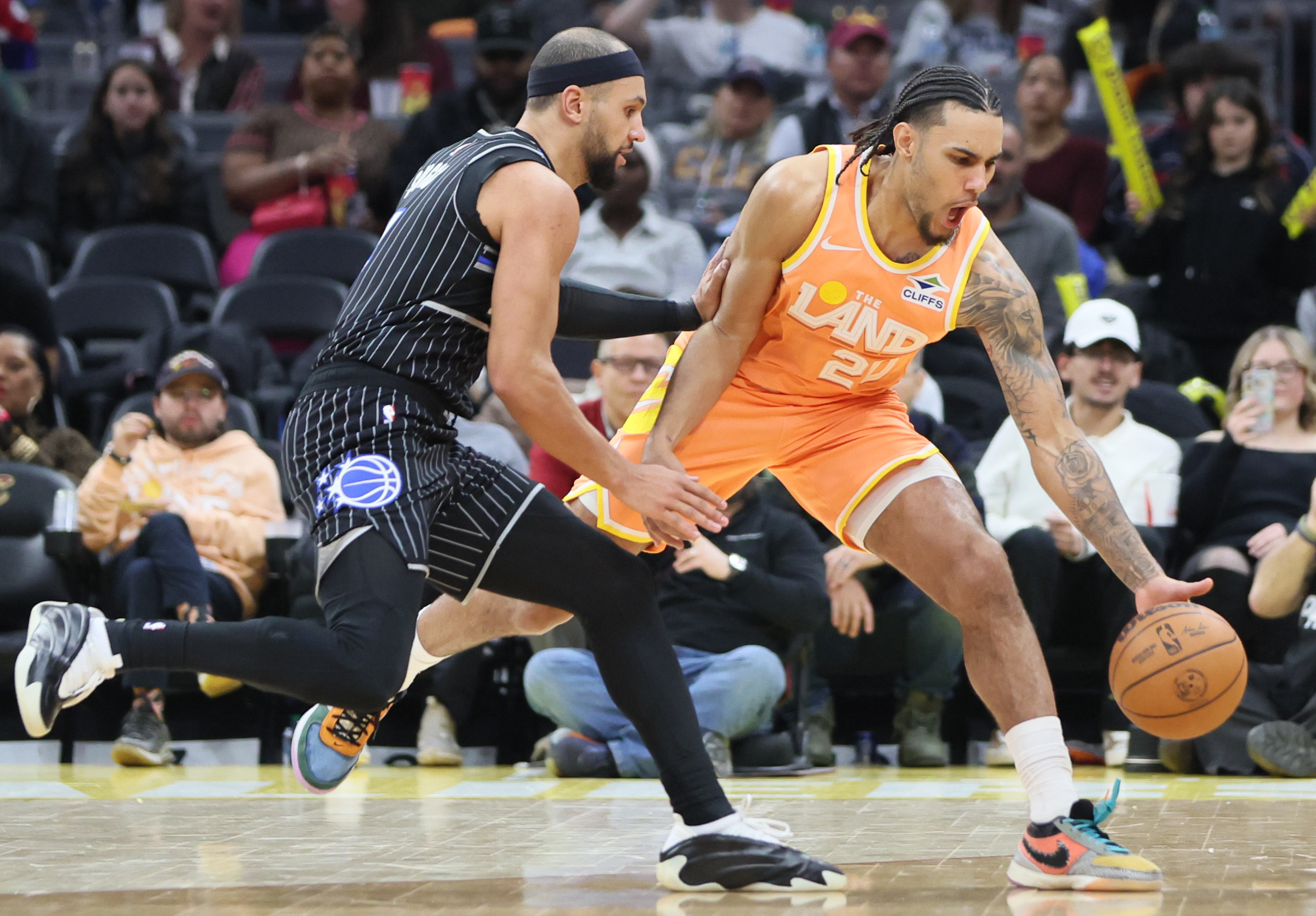 Cleveland Cavaliers guard Jaylon Tyson save the basketball from going out of bounds chased by Orlando Magic guard Jalen Suggs in the second half. 