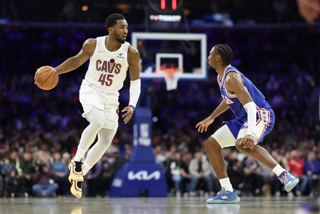 Donovan Mitchell of the Cleveland Cavaliers dribbling the ball while being guarded by Tyrese Maxey of the Philadelphia 76ers.