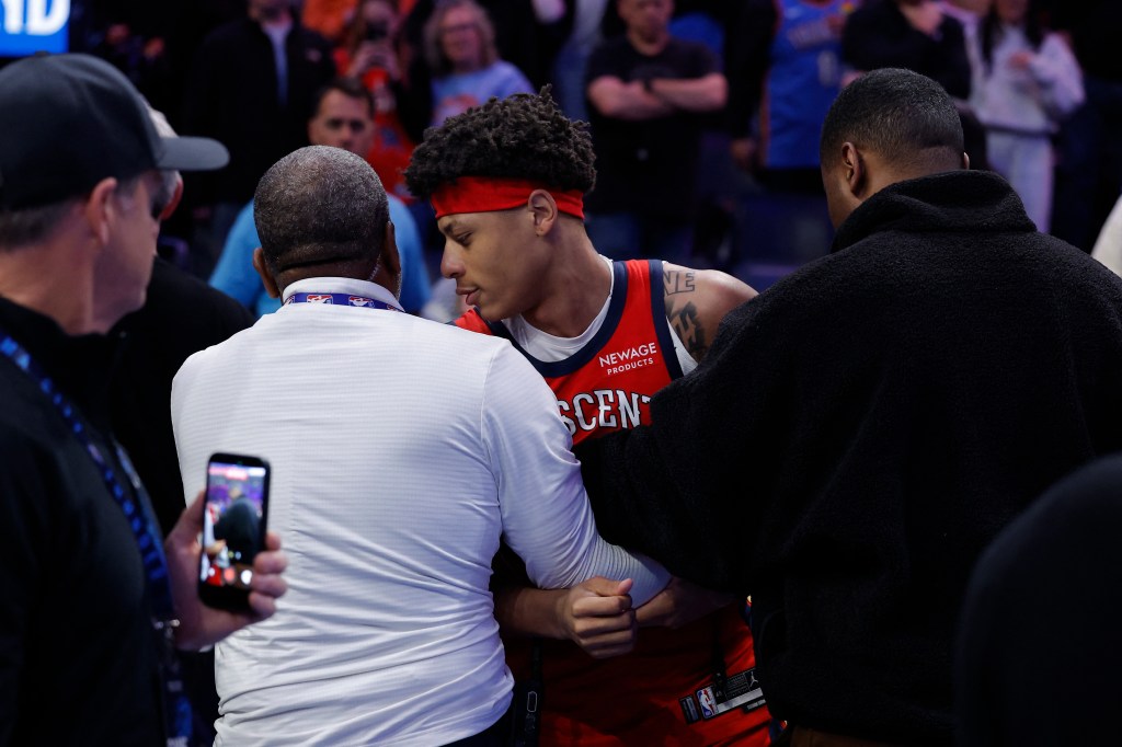 New Orleans Pelicans guard Jeremiah Fears (0) is taken off the court after a fight with Oklahoma City Thunder guard Luguentz Dort (5) at the end of the game at Paycom Center.