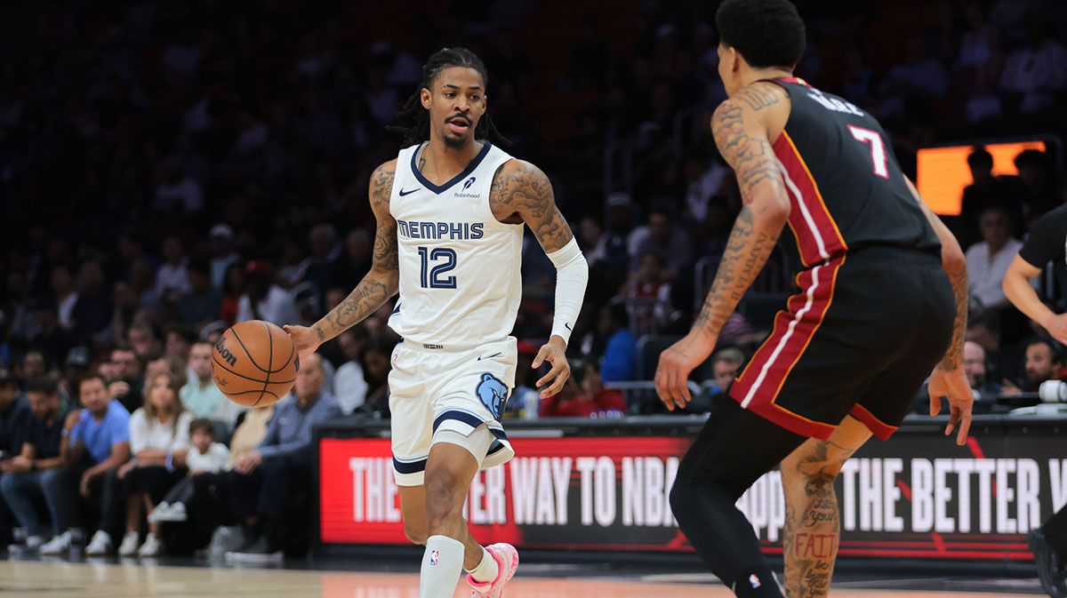 Memphis Grizzlies guard Ja Morant (12) dribbles the basketball as Miami Heat center Kel'el Ware (7) defends during the first quarter at Kaseya Center.