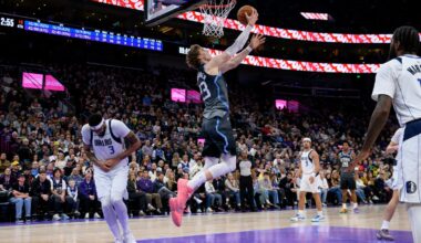 Mavericks' forward Anthony Davis (left) holds his hand in pain as Jazz forward Lauri Markkanen goes up for a layup in the fourth quarter.