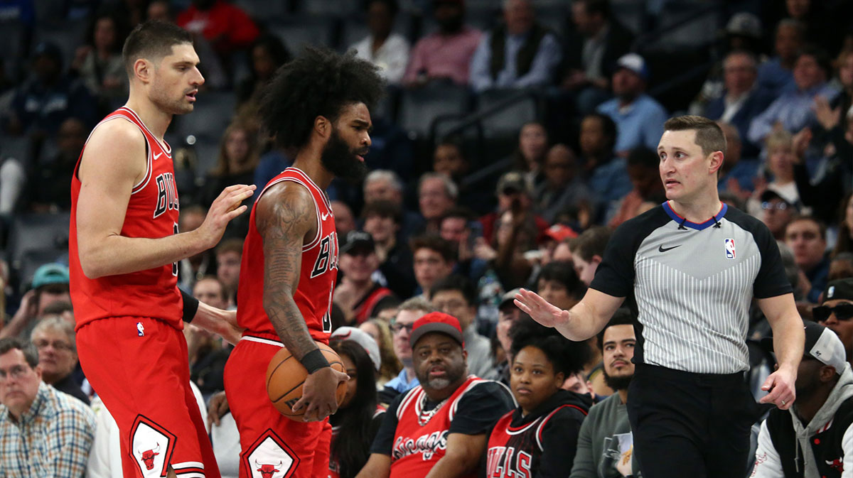 Chicago Bulls guard Coby White (0) reacts toward an official after an offensive foul as Chicago Bulls center Nikola Vucevic (9) holds him back at FedExForum. White received a technical foul.