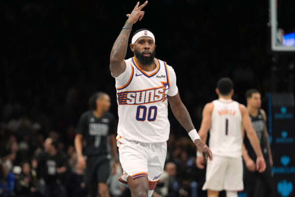Phoenix Suns' Royce O'Neale (00) gestures after making athree-point shot during the second half of an NBA basketball game against the Brooklyn Nets Monday, Jan. 19, 2026, in New York. (AP Photo/Frank Franklin II)