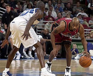 Magic point guard Darrell Armstrong guards his former teammate Chucky Atkins.