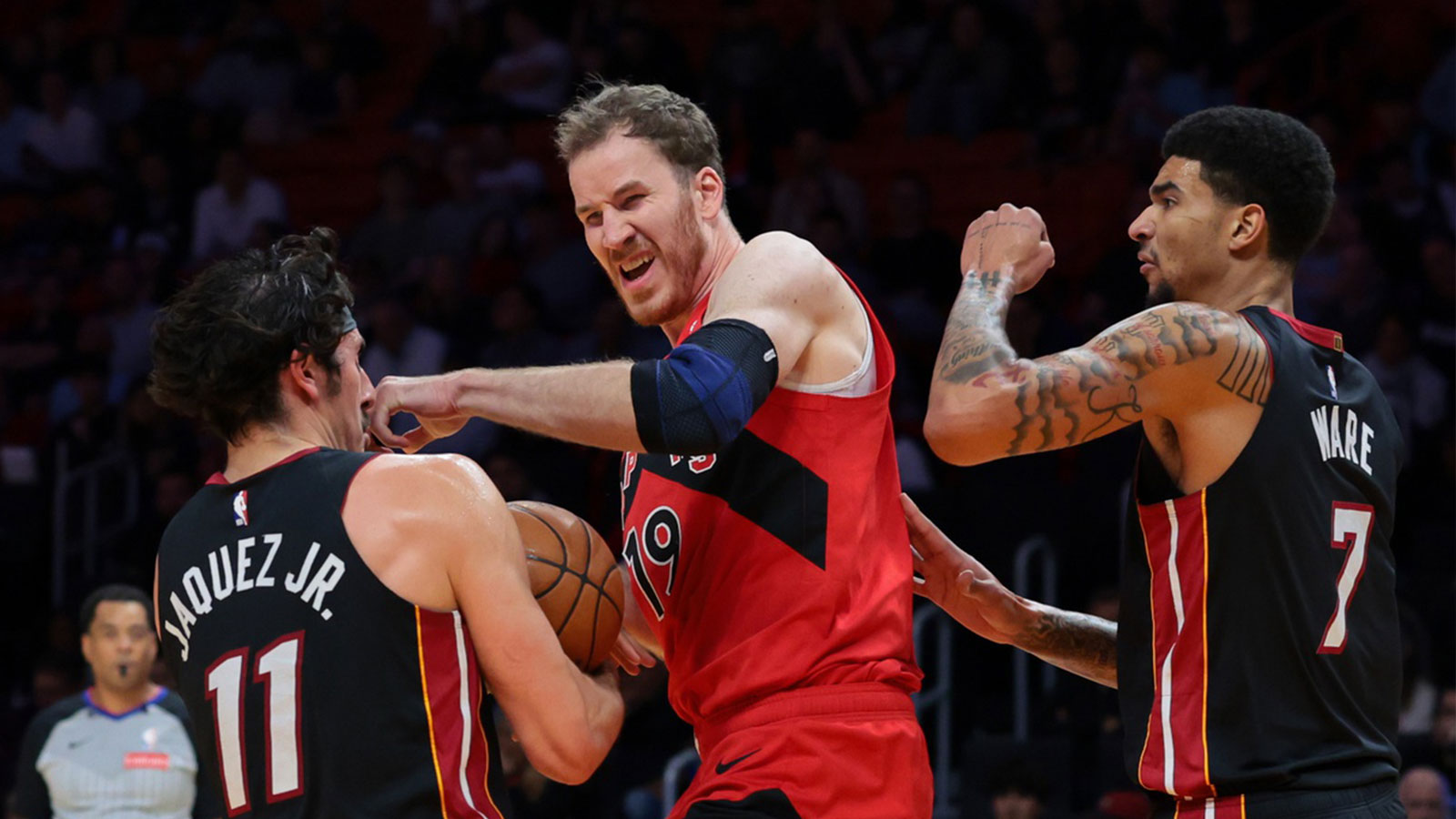 Miami Heat forward Jaime Jaquez Jr. (11) grabs a rebound against Toronto Raptors center Jakob Poeltl (19) during the second quarter at Kaseya Center.