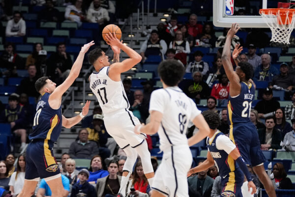 Brooklyn Nets forward Michael Porter Jr. (17) shoots between New Orleans Pelicans center Yves Missi (21) and forward Karlo Matkovic (17) in the first half of an NBA basketball game, Wednesday, Jan. 14, 2026, in New Orleans. (AP Photo/Gerald Herbert)