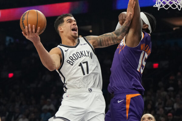 Brooklyn Nets forward Michael Porter Jr. shoots on Phoenix Suns center Mark Williams (15) during the first half of an NBA basketball game, Tuesday, Jan. 27, 2026, in Phoenix. (AP Photo/Rick Scuteri)