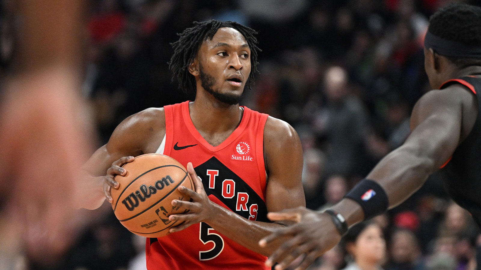 Toronto Raptors guard Immanuel Quickley (5) controls the ball against the Philadelphia 76ers in the second half at Scotiabank Arena.