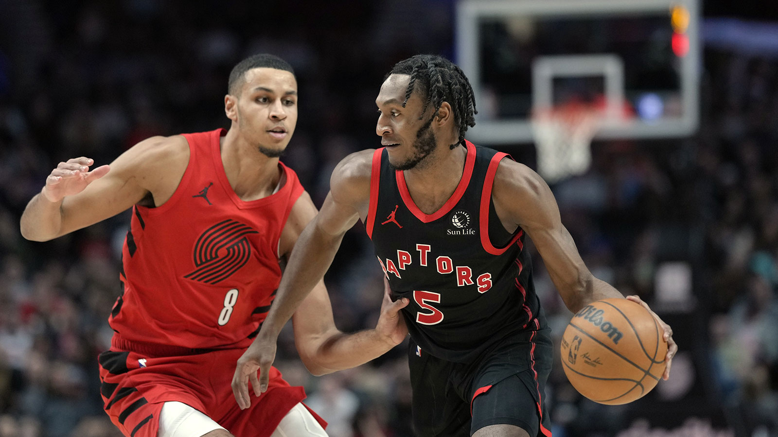 Toronto Raptors shooting guard Immanuel Quickly (5) dribbles the ball while defended by Portland Trail Blazers forward Kris Murray (8) during the first half at Moda Center. 