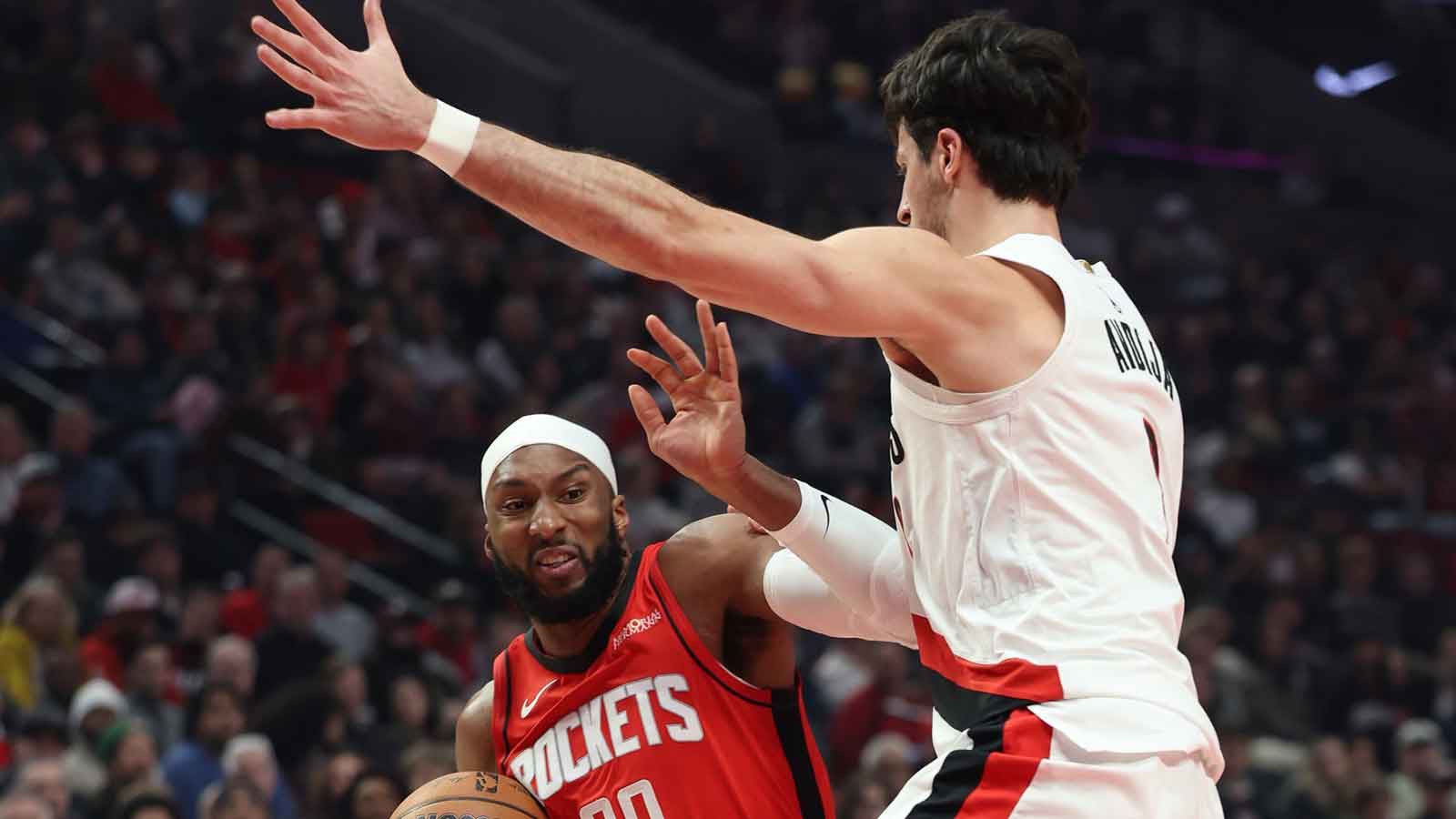 Jan 7, 2026; Portland, Oregon, USA; Houston Rockets guard Josh Okogie (20) shoots the ball against Portland Trail Blazers forward Deni Avdija (8) during the first half at Moda Center. Mandatory Credit: Jaime Valdez-Imagn Images