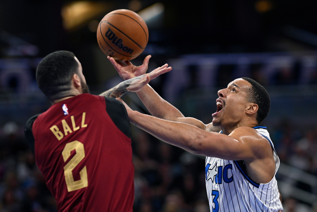 Orlando Magic guard Desmond Bane (3) is fouled by Cleveland Cavaliers guard Lonzo Ball (2) while going up to shoot during the first half of an NBA basketball game, Saturday, Jan. 24, 2026, in Orlando, Fla. (AP Photo/Phelan M. Ebenhack)