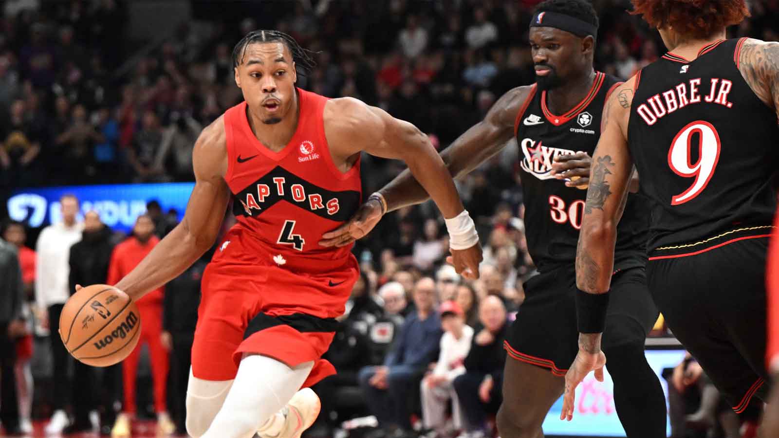 Toronto Raptors forward Scottie Barnes (4) dribbles the ball past Philadelphis 76ers center Adam Bona (30) in the second half at Scotiabank Arena.