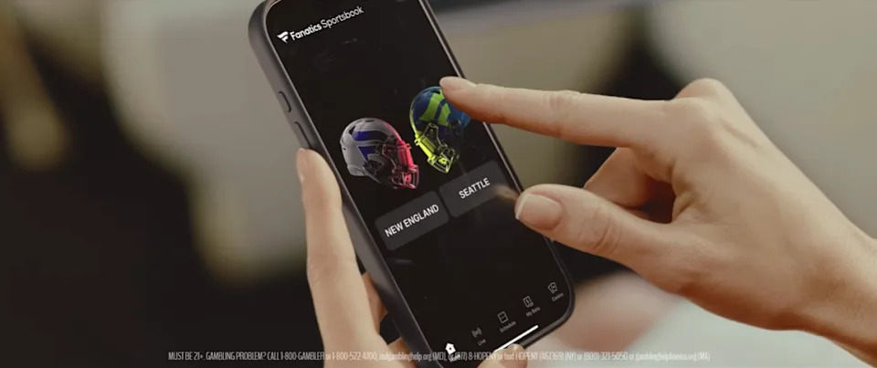 A close-up shot highlights the Fanatics Sportsbook app interface as part of Kendall Jenner’s Super Bowl commercial storyline.