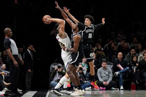 Brooklyn Nets guard Nolan Traore (88) and Brooklyn Nets center Day'ron Sharpe (20) block Denver Nuggets forward Aaron Gordon (32) during the first half of an NBA basketball game Sunday, Jan. 4, 2026, in New York. (AP Photo/Yuki Iwamura)