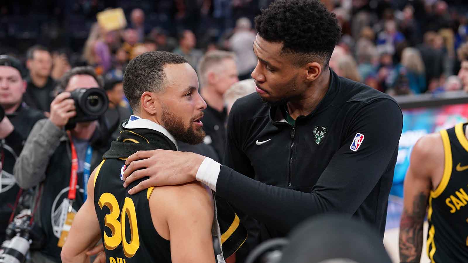 Milwaukee Bucks forward Giannis Antetokounmpo (34) and Golden State Warriors guard Stephen Curry (30) meet after the game at the Chase Center.