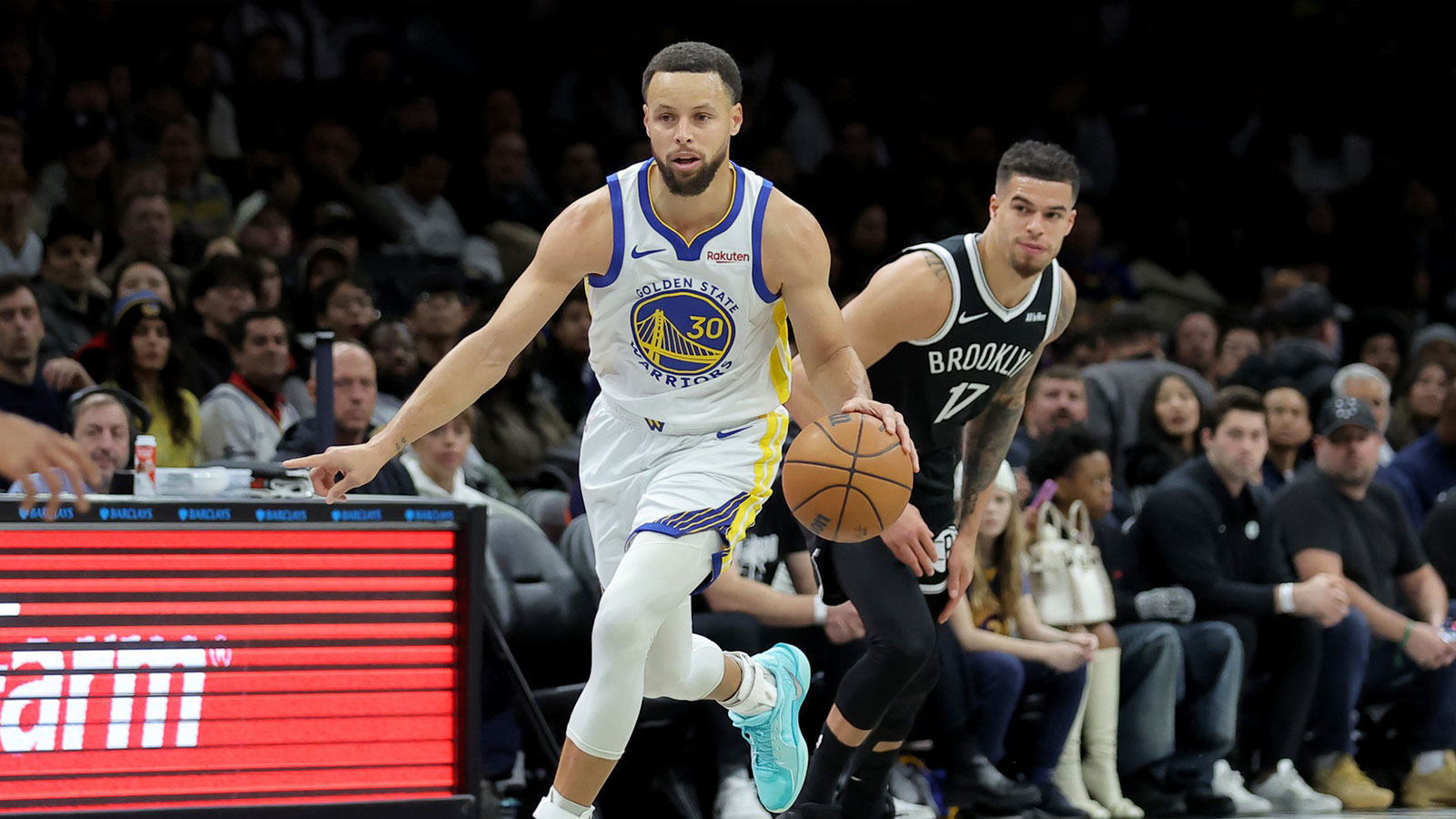 Golden State Warriors guard Stephen Curry (30) brings the ball up court against Brooklyn Nets forward Michael Porter Jr. (17) during the first quarter at Barclays Center. 