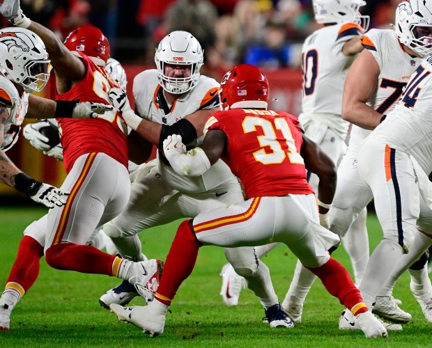 Denver Broncos center Alex Forsyth (54) keeps his eyes on Kansas City Chiefs linebacker Jeffrey Bassa (31) during the game at GEHA Field at Arrowhead Stadium in Kansas City, Missouri on Thursday, Dec. 25, 2025. (Photo by Andy Cross/The Denver Post)