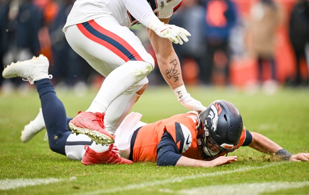 Christian Elliss (53) of the New England Patriots forces Jarrett Stidham (8) of the Denver Broncos to the ground after a turnover during the second quarter at Empower Field at Mile High in Denver on Sunday, Jan. 25, 2026. (Photo by AAron Ontiveroz/The Denver Post)