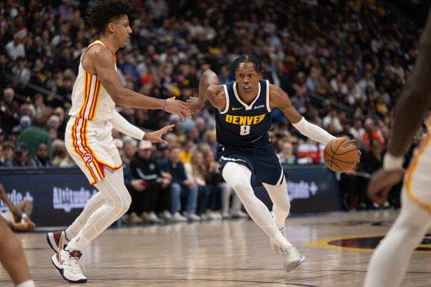 Peyton Watson (8) of the Denver Nuggets drives on Jalen Johnson (1) of the Atlanta Hawks during the first half of a 110-87 Nuggets loss on Friday, Jan. 9, 2026, at Ball Arena in Denver. (Photo by Timothy Hurst/The Denver Post)