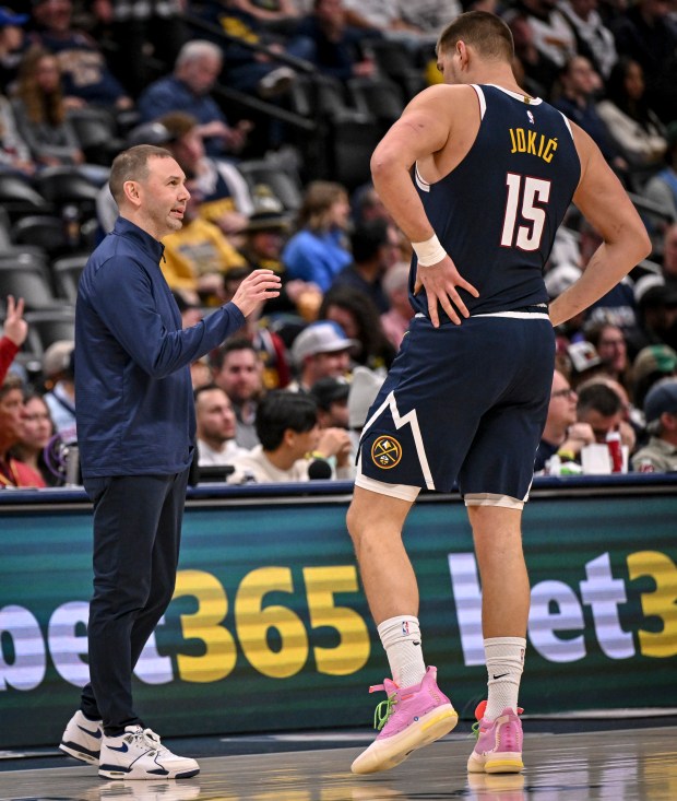 DENVER , CO - DECEMBER 18: Head coach David Adelman of the Denver Nuggets talks to Nikola Jokic (15) during the fourth quarter of the Nuggets' 126-115 win over the Orlando Magic at Ball Arena in Denver, Colorado on Thursday, December 18, 2025. (Photo by AAron Ontiveroz/The Denver Post)