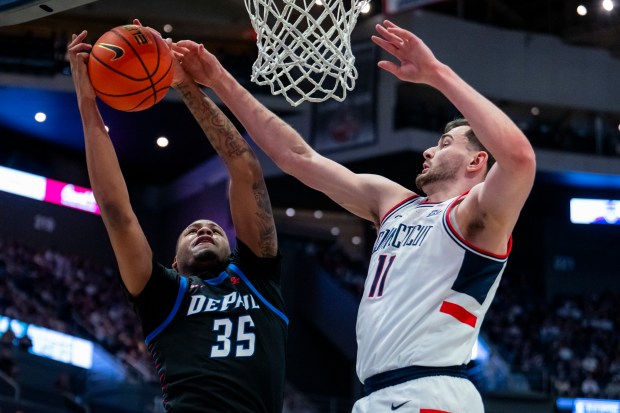 HARTFORD, CONNECTICUT - JANUARY 10: NJ Benson #35 of the DePaul Blue Demons gets the rebound against Alex Karaban #11 of the Connecticut Huskies during the first half of an NCAA men's basketball game at PeoplesBank Arena on January 10, 2026 in Hartford, Connecticut. (Photo by Joe Buglewicz/Getty Images)