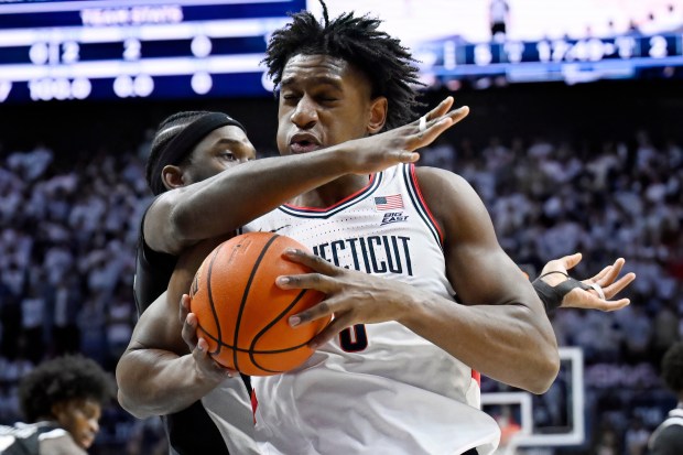 UConn forward Tarris Reed Jr., right, is guarded by Providence forward Oswin Erhunmwunse in the first half of an NCAA college basketball game, Tuesday, Jan. 27, 2026, in Storrs, Conn. (AP Photo/Jessica Hill)