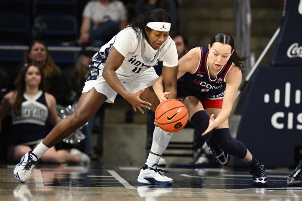 UConn guard Kayleigh Heckel, right, and Georgetown guard Laila Jewett, left, battle for the ball during the first half of an NCAA college basketball game, Thursday, Jan. 22, 2026, in Washington. (AP Photo/Nick Wass)