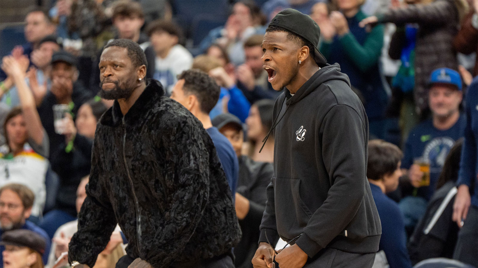 Timberwolves guard Anthony Edwards (5) and forward Julius Randle (30) celebrate taking the lead against the Portland Trail Blazers in the fourth quarter at Target Center