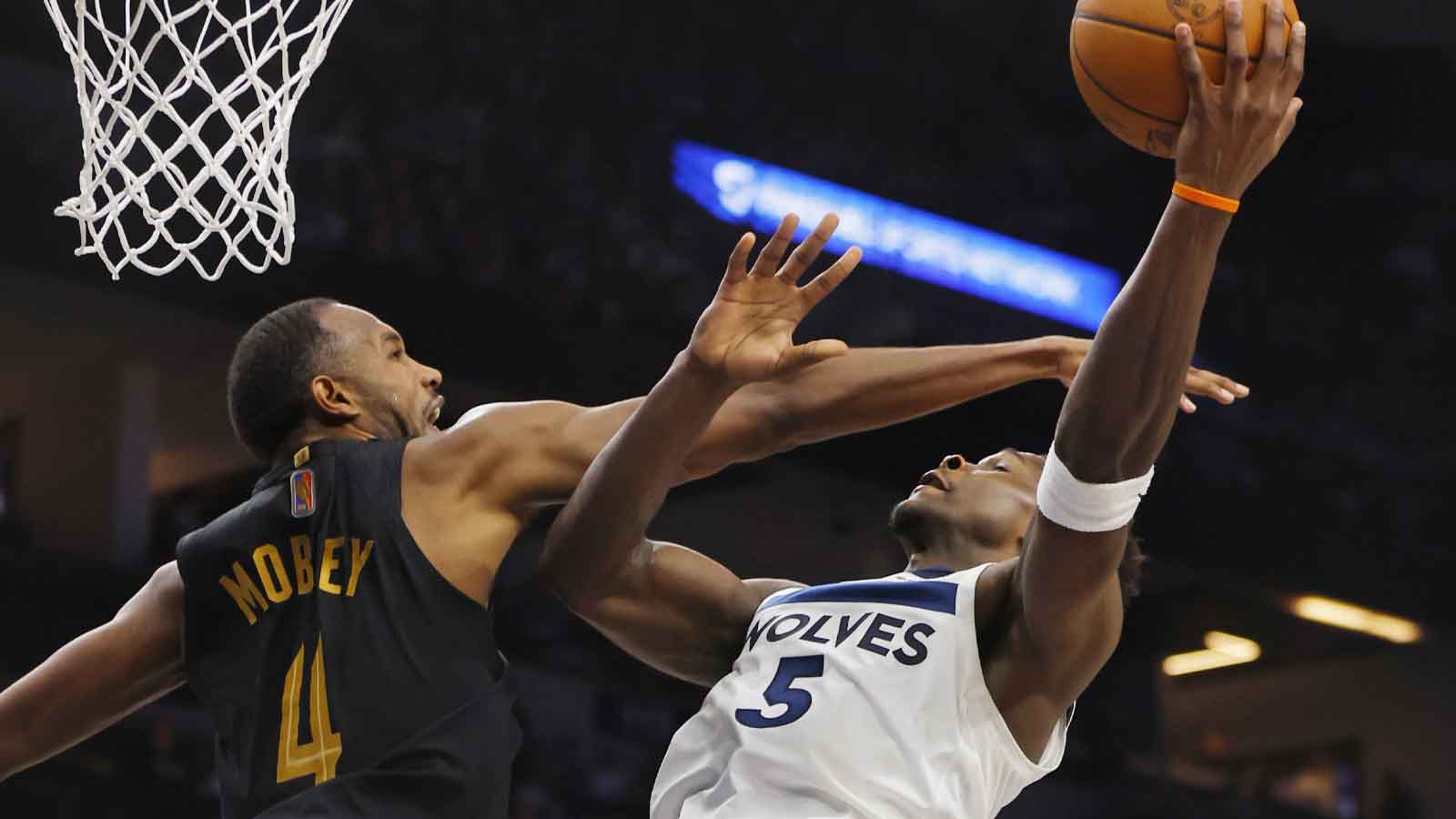 Cleveland Cavaliers forward Evan Mobley (4) defends against Minnesota Timberwolves guard Anthony Edwards (5) in the fourth quarter at Target Center.
