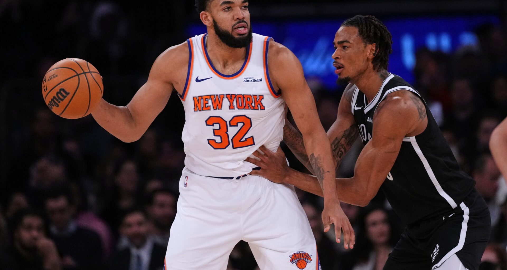 New York Knicks' Karl-Anthony Towns (32) protects the ball from Brooklyn Nets' Nic Claxton (33) during the second half of an NBA basketball game Wednesday, Jan. 21, 2026, in New York. (AP Photo/Frank Franklin II)