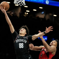 Brooklyn Nets guard Nolan Traore (88) shoots over Toronto Raptors forward Scottie Barnes (4) during the second half of an NBA basketball game, Sunday, Dec. 21, 2025, in New York. (AP Photo/Yuki Iwamura)
