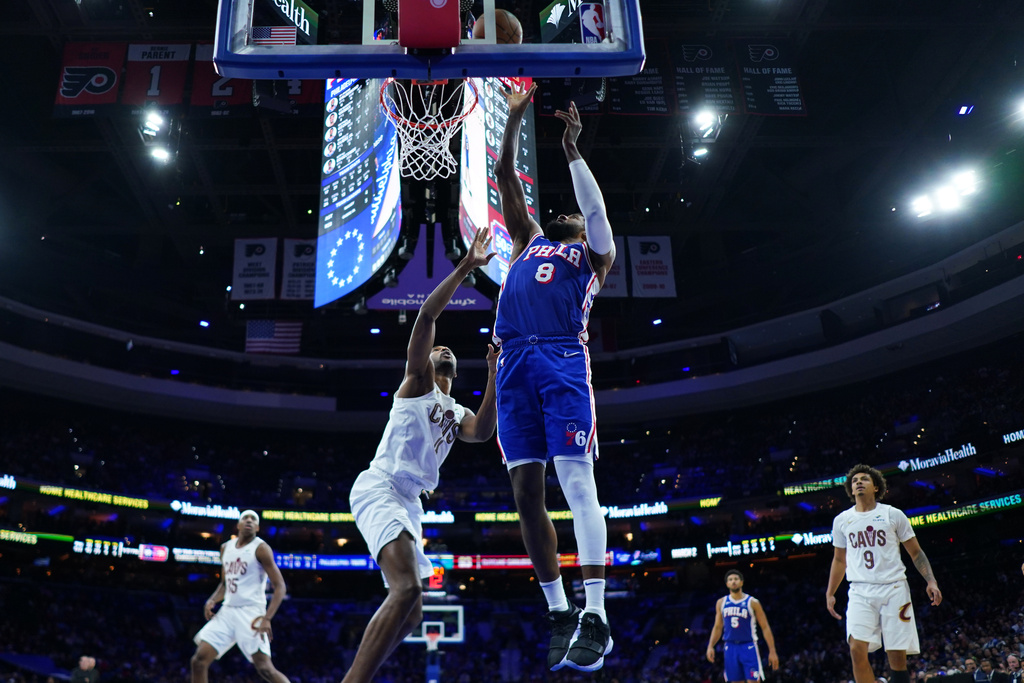 Philadelphia 76ers' Paul George (8) goes up for a shot against Cleveland Cavaliers' Evan Mobley (4) during the second half of an NBA basketball game Wednesday, Jan. 14, 2026, in Philadelphia. 