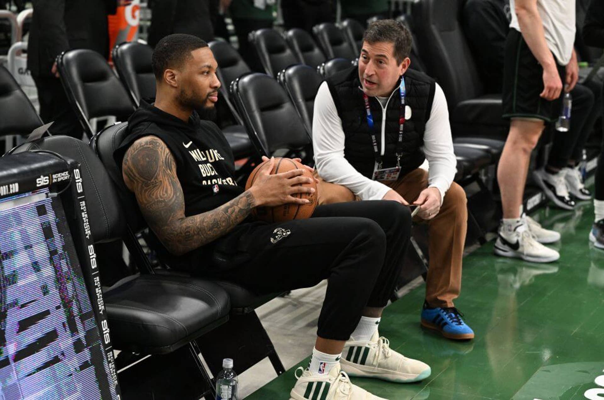Milwaukee Bucks President Peter Feigin and guard Damian Lillard talk during shootaround before a game against the New York Knicks at Fiserv Forum.