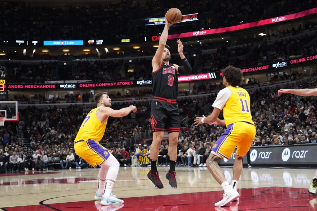 Mar 27, 2025; Chicago, Illinois, USA; Chicago Bulls center Nikola Vucevic (9) shoots over Los Angeles Lakers center Jaxson Hayes (11) during the first quarter at United Center. Mandatory Credit: David Banks-Imagn Images