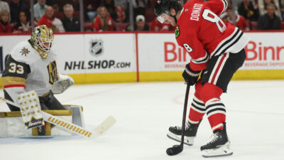 Mar 28, 2025; Chicago, Illinois, USA; Chicago Blackhawks center Ryan Donato (8) scores on Vegas Golden Knights goaltender Adin Hill (33) during the first period at United Center. Mandatory Credit: Talia Sprague-Imagn Images