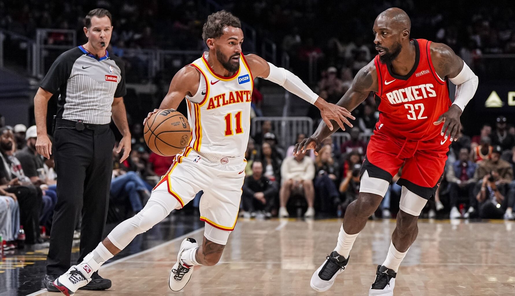 Oct 16, 2025; Atlanta, Georgia, USA; Atlanta Hawks guard Trae Young (11) dribbles against Houston Rockets forward Jeff Green (32) during the first half at State Farm Arena. Mandatory Credit: Dale Zanine-Imagn Images