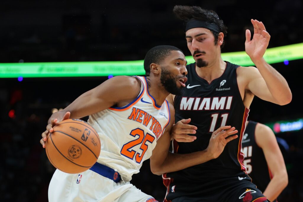 Oct 26, 2025; Miami, Florida, USA; New York Knicks guard Mikal Bridges (25) drives to the basket against Miami Heat forward Jaime Jaquez Jr. (11) during the fourth quarter at Kaseya Center. Mandatory Credit: Sam Navarro-Imagn Images