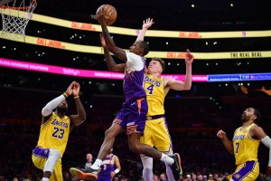 Dec 1, 2025; Los Angeles, California, USA; Phoenix Suns guard Jamaree Bouyea (17) moves to the basket against Los Angeles Lakers forward Dalton Knecht (4) during the first half at Crypto.com Arena. Mandatory Credit: Gary A. Vasquez-Imagn Images