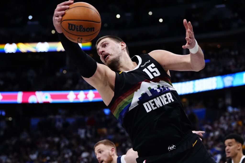 Denver Nuggets center Nikola Jokic (15) reaches for a rebound in overtime against the Minnesota Timberwolves at Ball Arena.