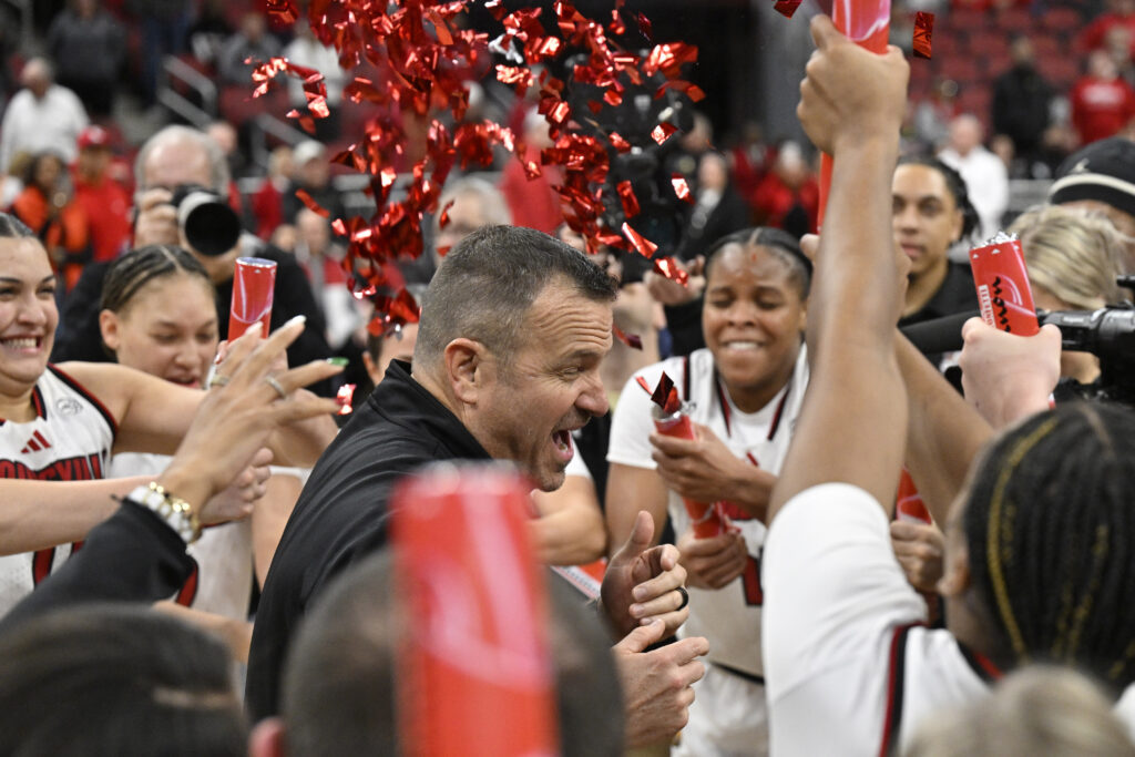 Louisville Cardinals head coach Jeff Walz celebrates his 500th win