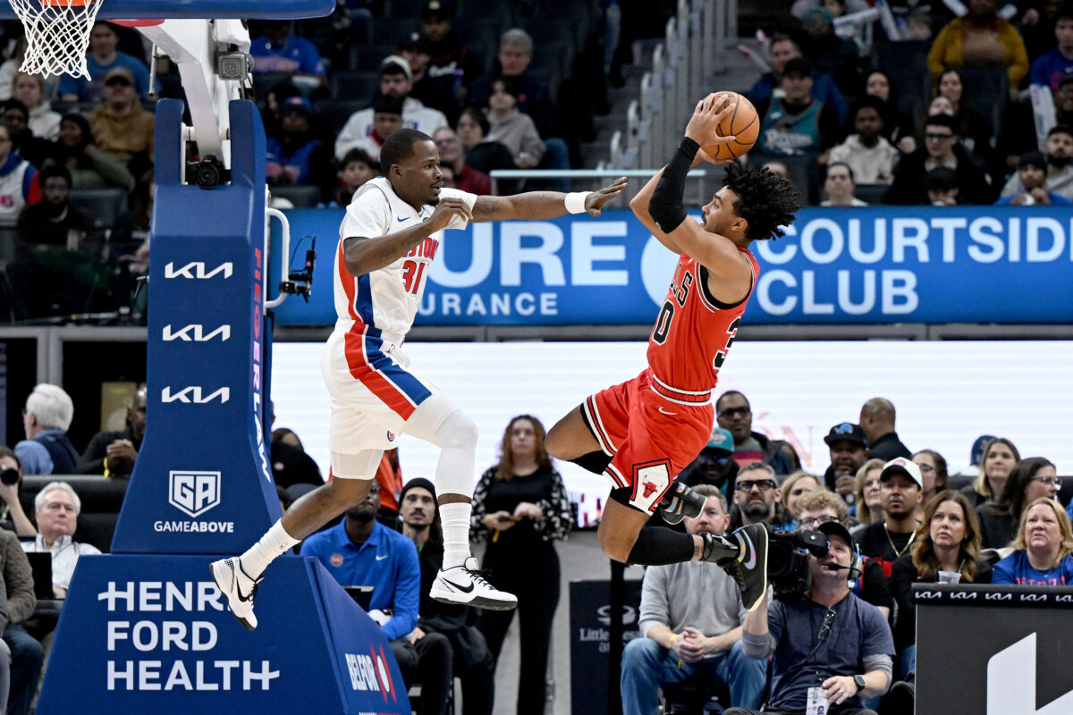 Jan 7, 2026; Detroit, Michigan, USA; Chicago Bulls guard Tre Jones (30) pulls up to shoot the ball over Detroit Pistons guard Javonte Green (31) in the first quarter at Little Caesars Arena. Mandatory Credit: Lon Horwedel-Imagn Images