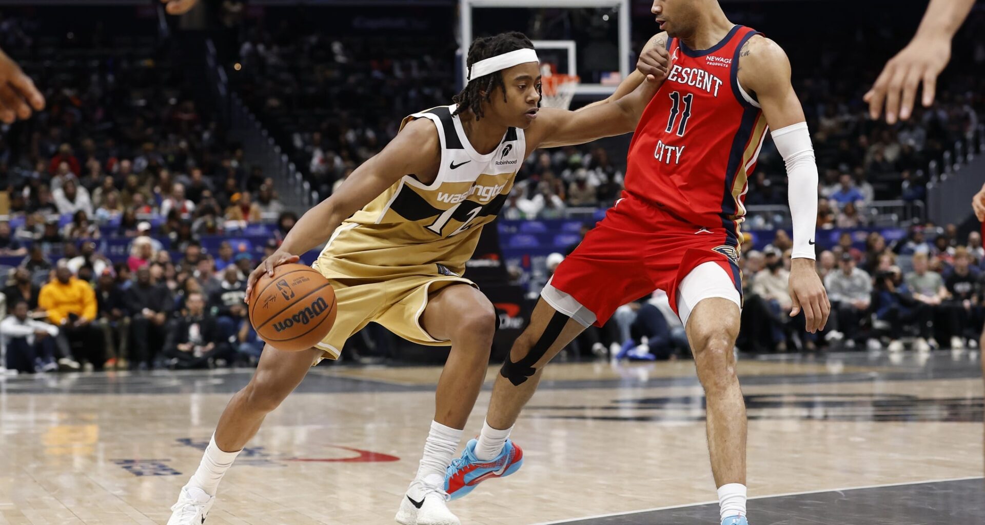 Jan 9, 2026; Washington, District of Columbia, USA; Washington Wizards guard Tre Johnson (12) drives to the basket as New Orleans Pelicans guard Bryce McGowens (11) defends in the second half at Capital One Arena. Mandatory Credit: Geoff Burke-Imagn Images