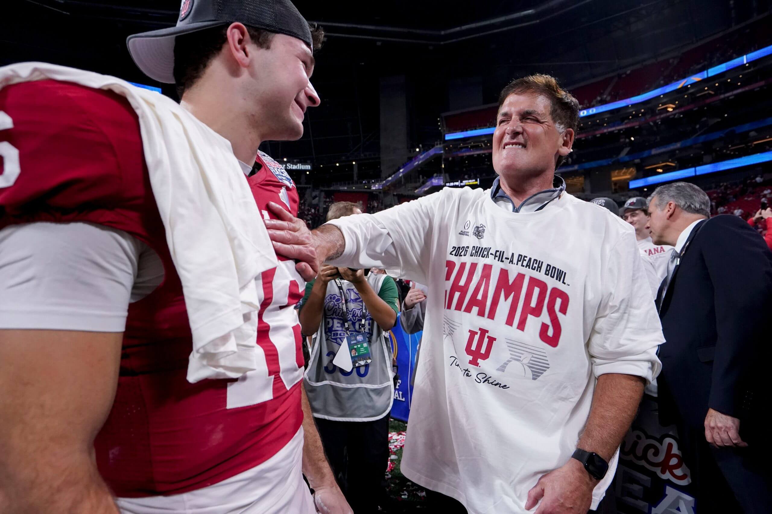 Mark Cuban pats Indiana QB Fernando Mendoza on the chest. 