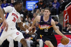 Jan 15, 2026; Detroit, Michigan, USA; Phoenix Suns guard Collin Gillespie (12) dribbles defended by Detroit Pistons guard Javonte Green (31) in the first half at Little Caesars Arena. Mandatory Credit: Rick Osentoski-Imagn Images